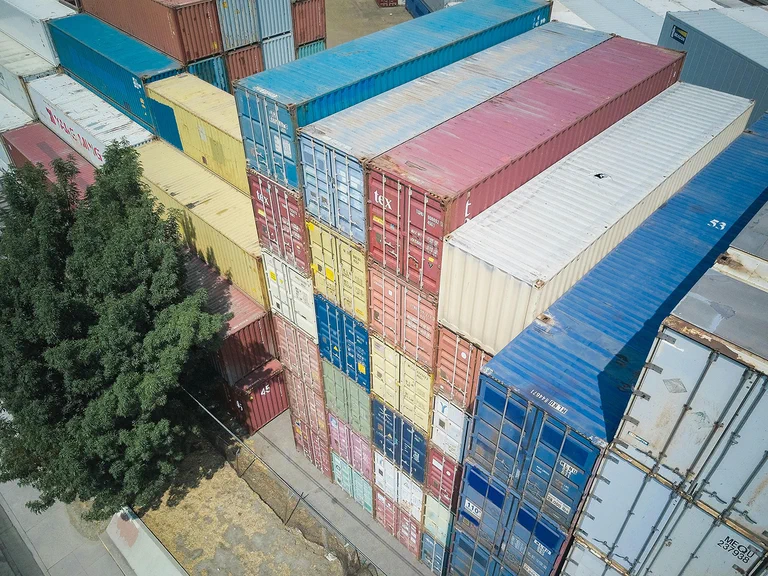 A photograph of stack of shipping containers.