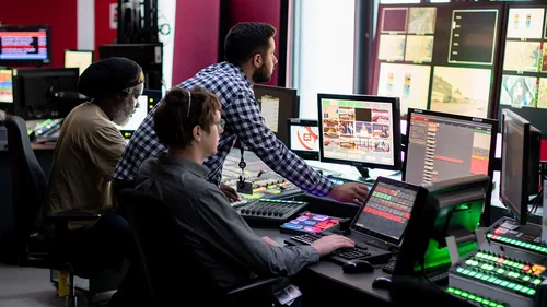 Photo of people monitoring transportation data on screens. Photo of people monitoring transportation data on screens.
