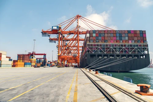 A photo of an active sea port at night.
